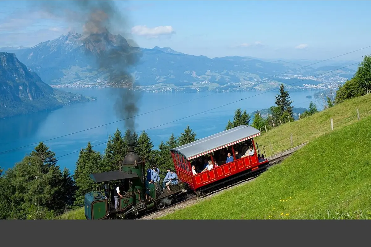 Historic Vitznau-Rigi steam train climbing Mount Rigi above Lake Lucerne