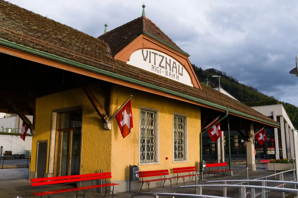 Vitznau Rigi-Bahn station on Lake Lucerne decorated with Swiss flags, the lakeside boarding point for the Rigi cogwheel railway