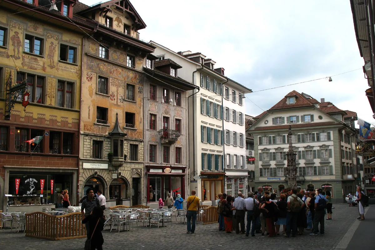 Cafe tables and painted facades on Weinmarkt square in Lucerne Old Town