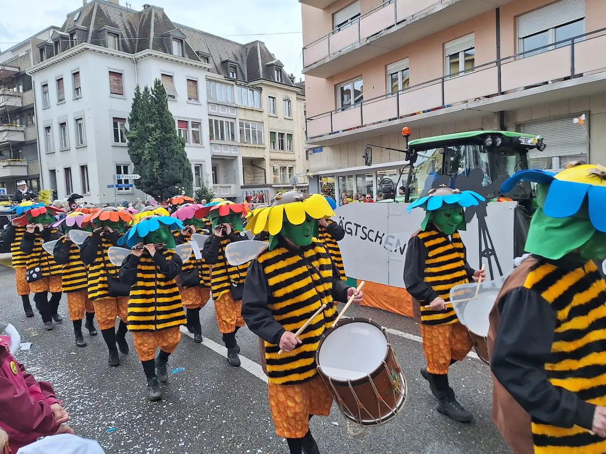Costumed drummers marching in the daytime Cortège at Basel Carnival 2025.