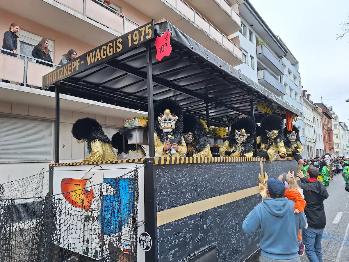 Costumed Guggenmusik musicians marching during Basel Carnival 2025.