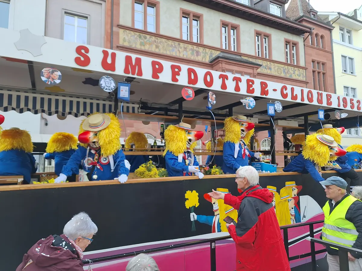 Waggis float moving through the daytime Basel Carnival Cortège 2025.