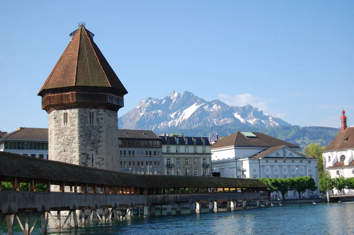 Chapel Bridge and Water Tower in Lucerne with Mount Pilatus behind the city