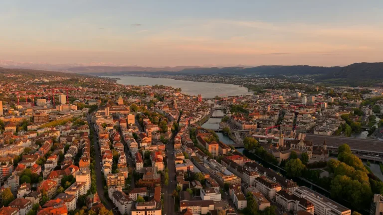 Aerial view of Zurich and Lake Zurich at golden hour with mountains in the distance
