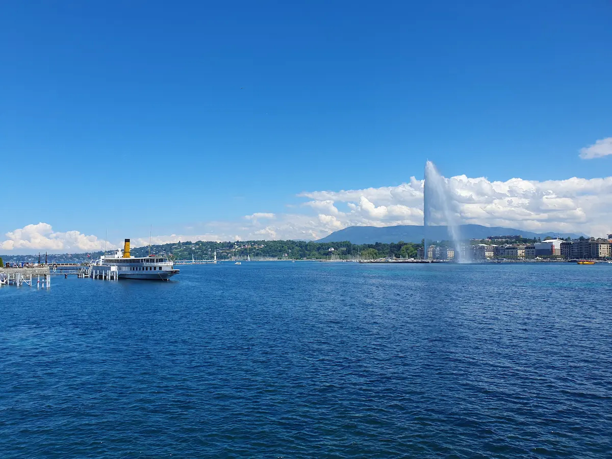 Lake Geneva with a passenger boat, Jet d'Eau and the Geneva waterfront