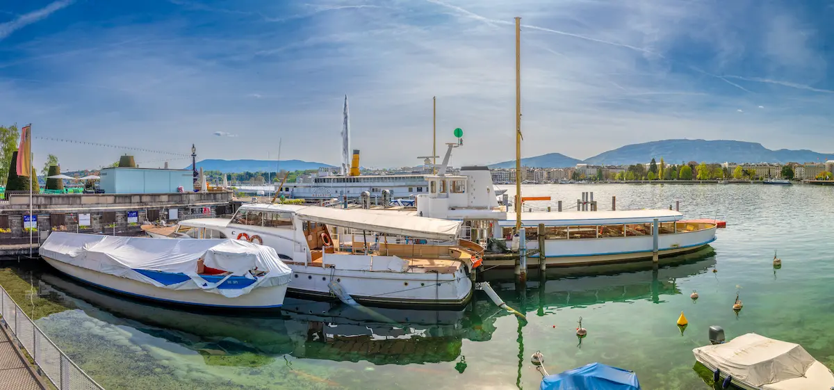 Port des Pâquis in Geneva with boats, Lake Geneva and the Jet d'Eau