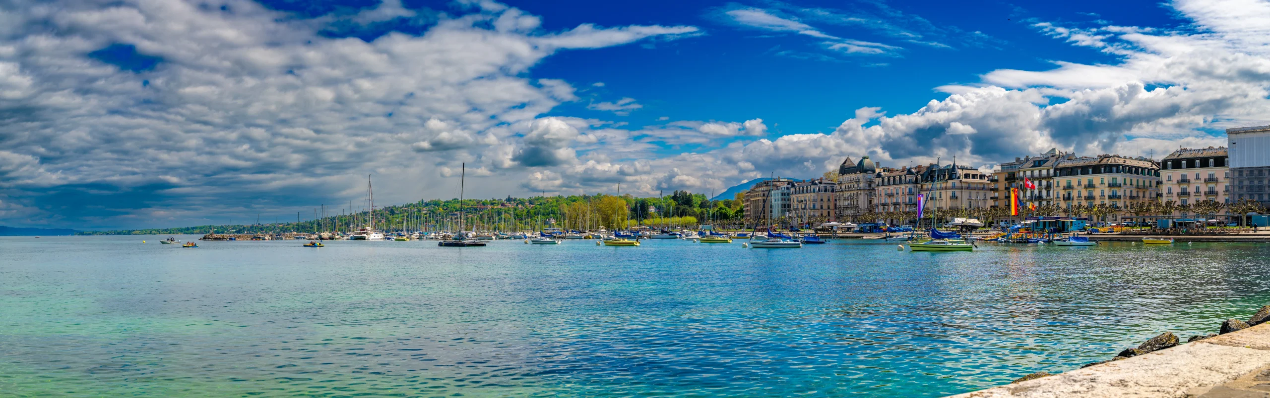 Yellow Mouette shuttle boat crossing Lake Geneva in central Geneva