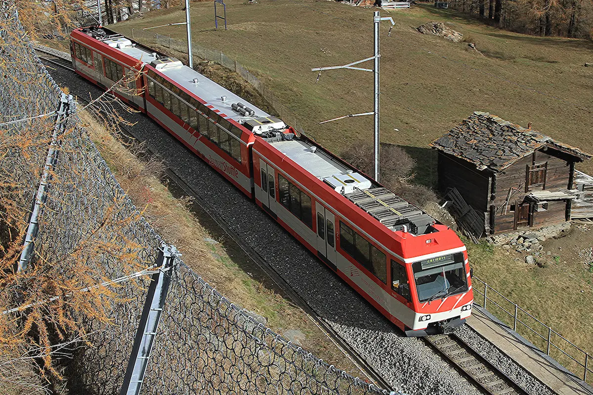 Red Matterhorn Gotthard Bahn Zermatt Shuttle train on the mountain railway toward Zermatt