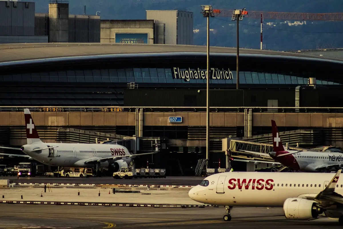 Zurich Airport terminal with Swiss aircraft, illustrating airport coverage in the Zurich Card vs ZVV 24-hour ticket comparison
