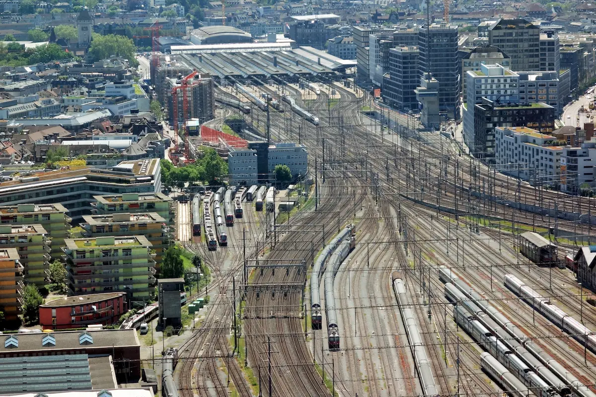 Wide aerial view of Zurich Hauptbahnhof rail approaches and surrounding city