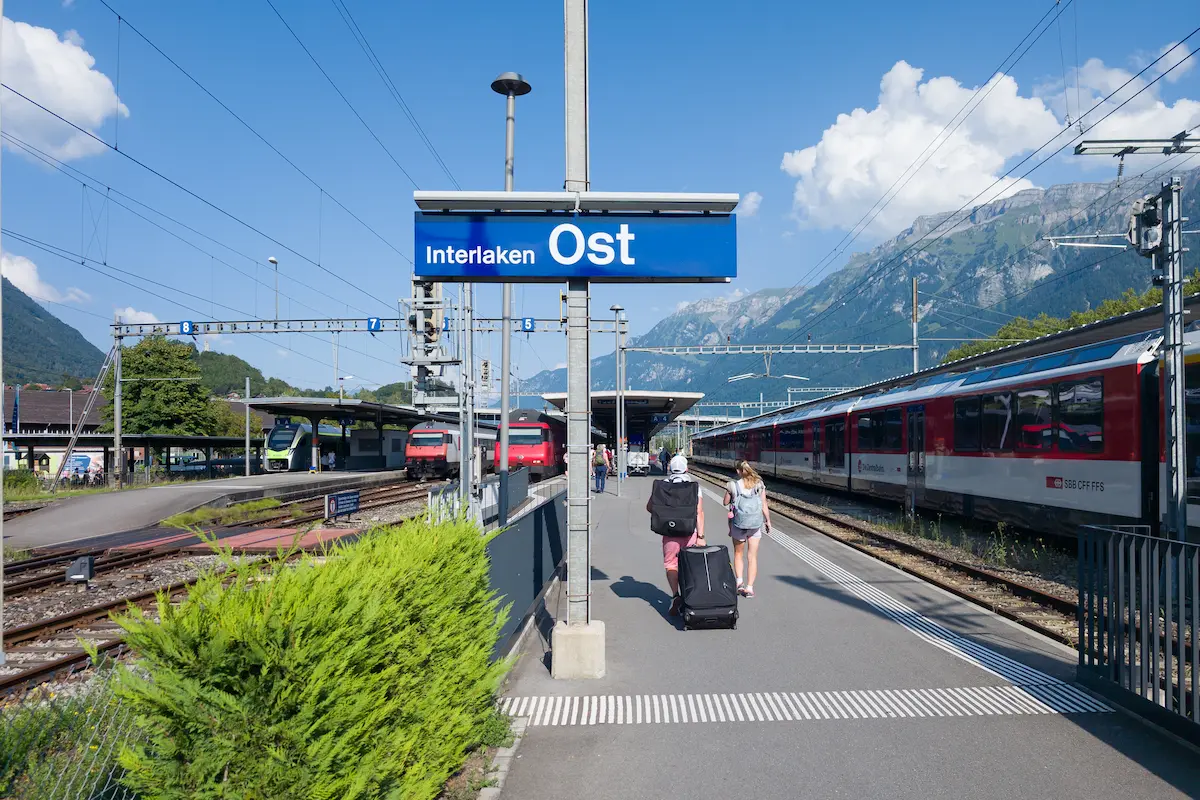 Interlaken Ost railway station platforms with the station sign and trains